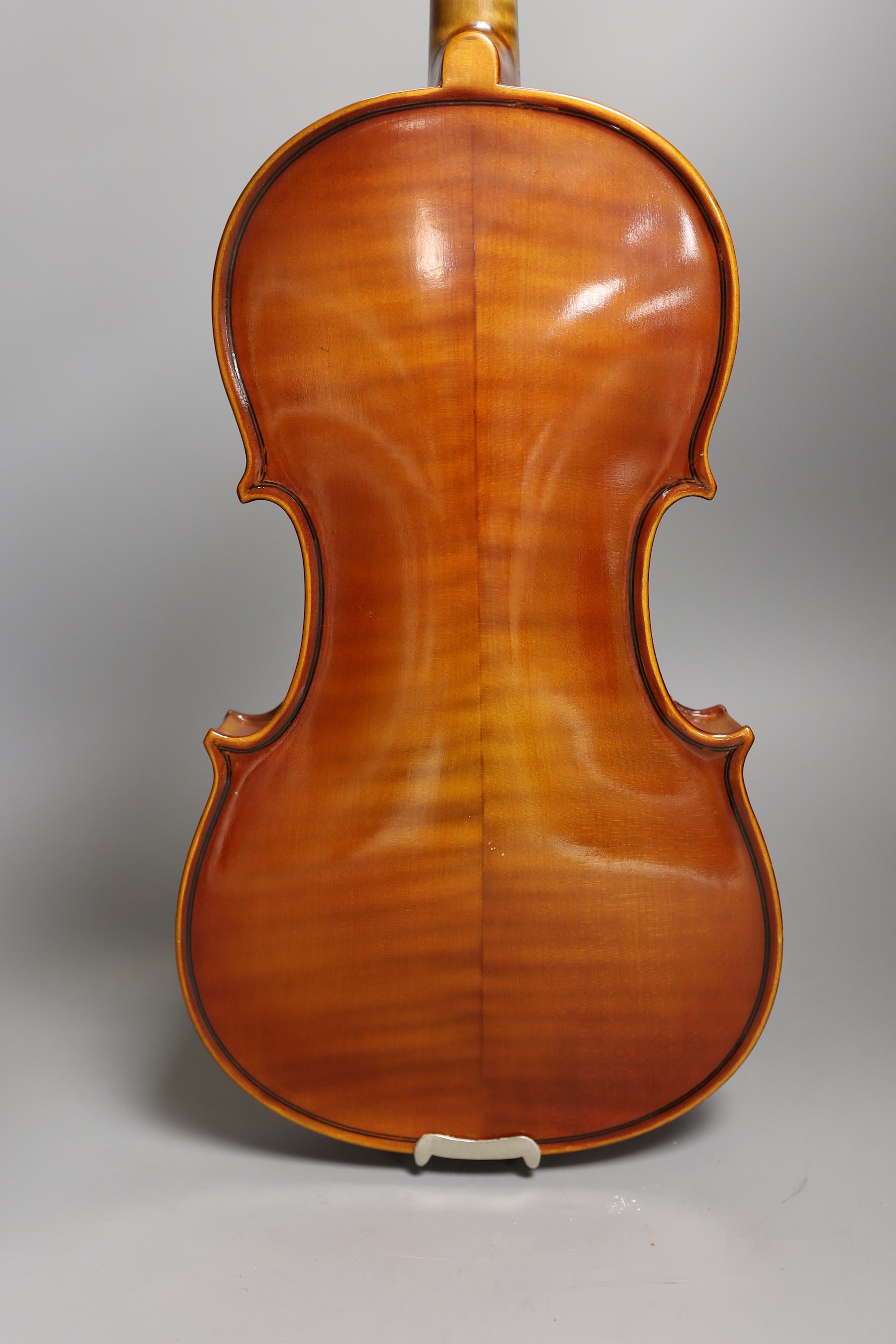 A cased child's violin and bow with ivorine tip, violin 55cms long